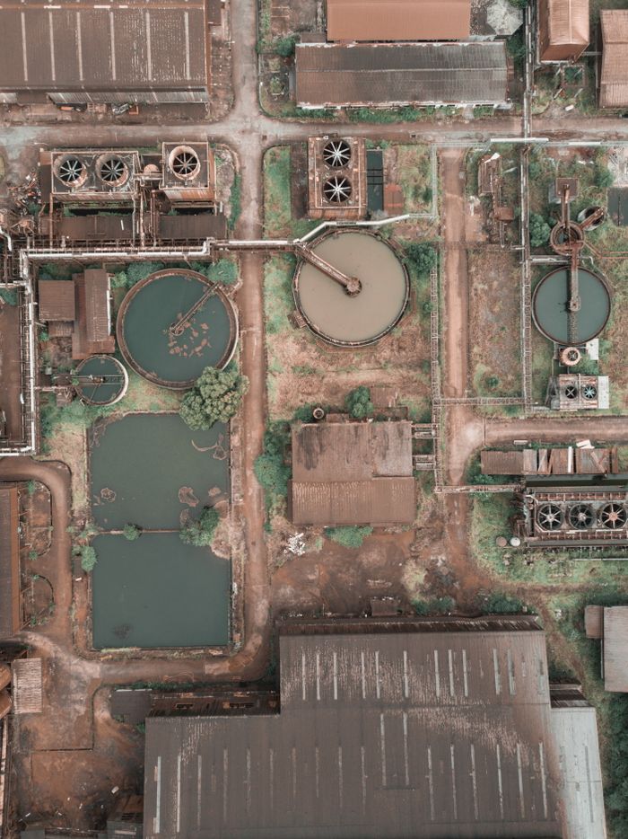 Crafting Captivating Headlines: Your awesome post title goes here From above aerial view of industrial area of sewage treatment plant with round shaped water clarifiers