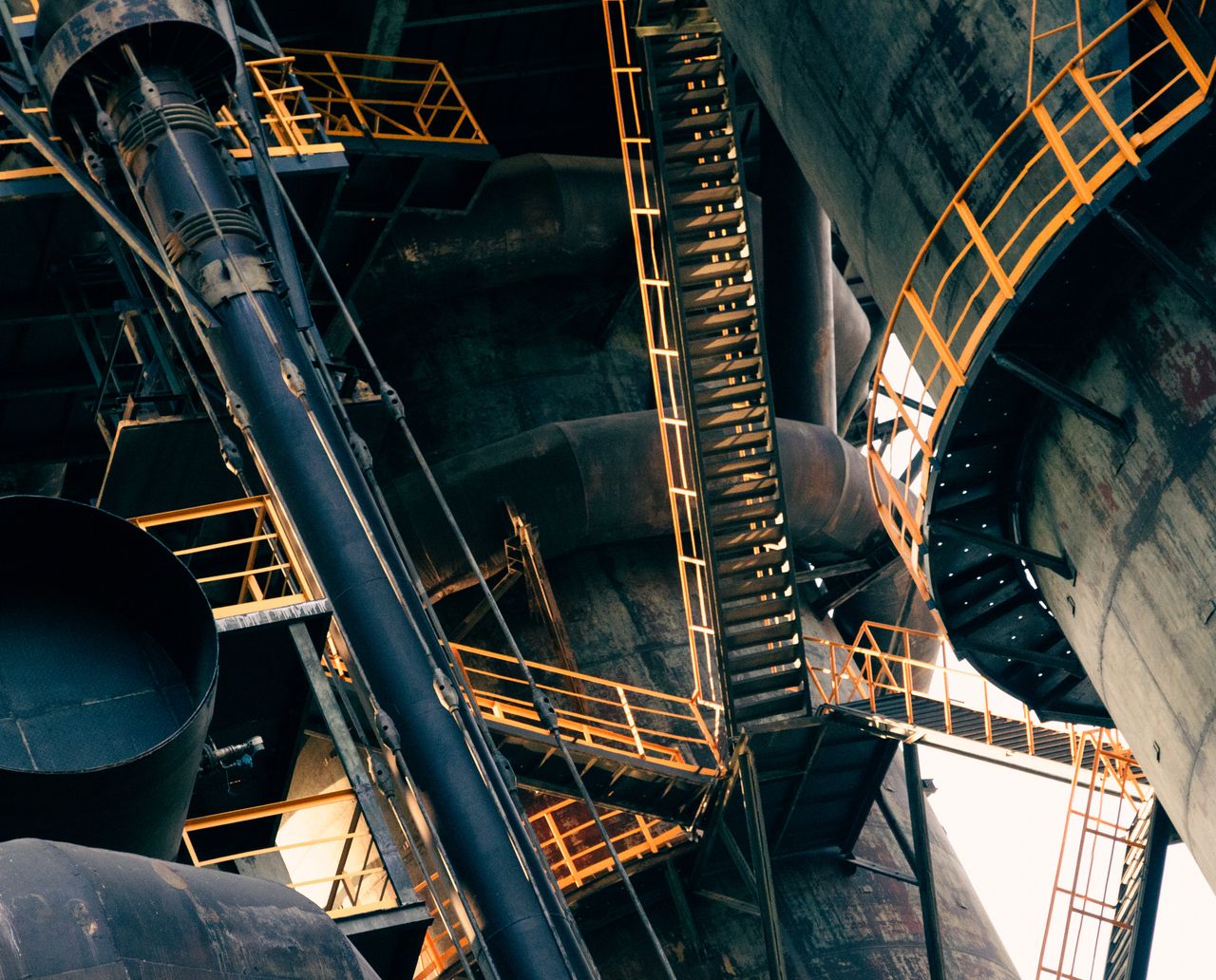 Mastering the First Impression: Your intriguing post title goes here Intricate view of metal stairs and structures in a large industrial facility.